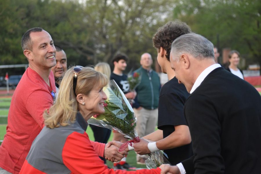 Dr. Reilly greets soccer senior players and their parents during the senior walk.