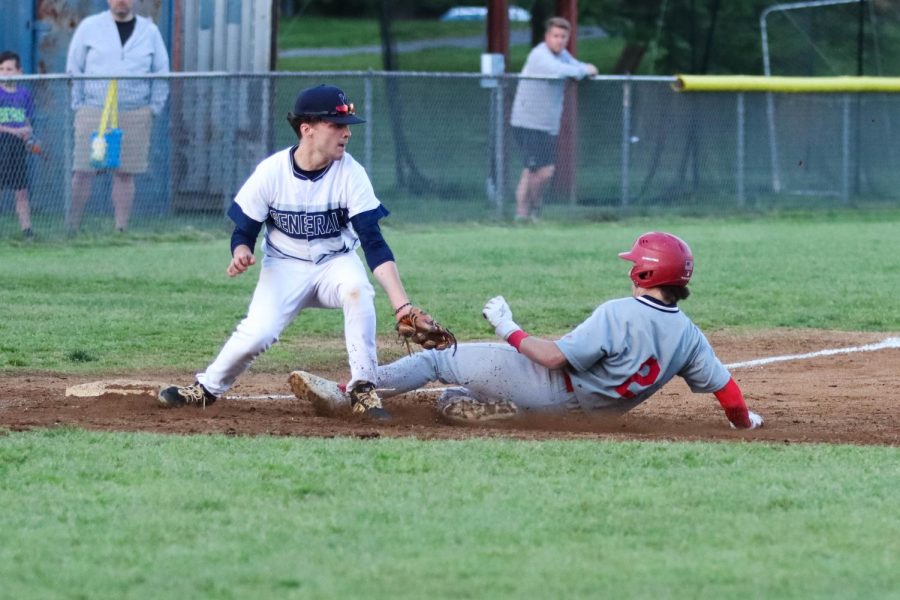 Junior Chris Morabito slides into 3rd base right before the ball catches him.