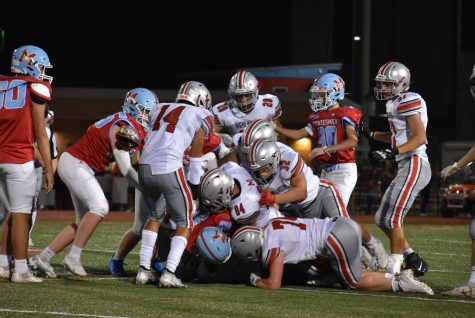 Highlanders dog pile on Marshall player to stop any further Statesmen progression towards the goal line.