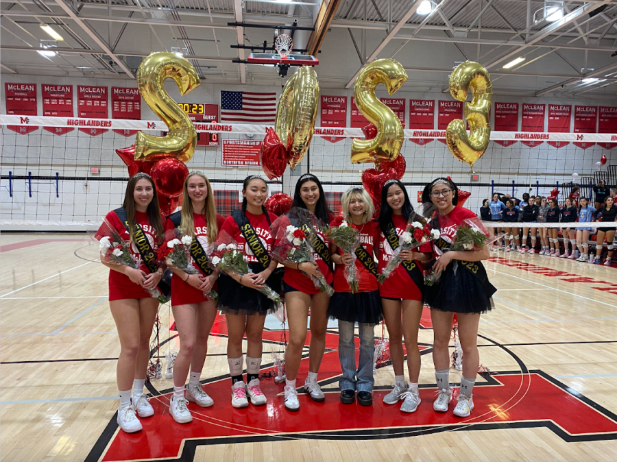 Seniors pose together to capture the memory of the night after being recognized in a ceremony before the game. Younger players and coaches came together to reward the seniors with a gift bag including the crowns and flowers.