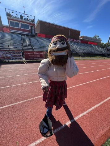 Angus poses for a picture in front of the bleachers right before performing at the pep rally. Image by Brooke Thomas.