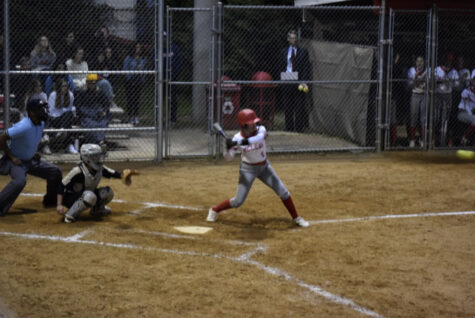 Junior Ella Templer hits a line drive that was caught by the Langley shortstop. Templer recently switched from playing outfield to shortstop.