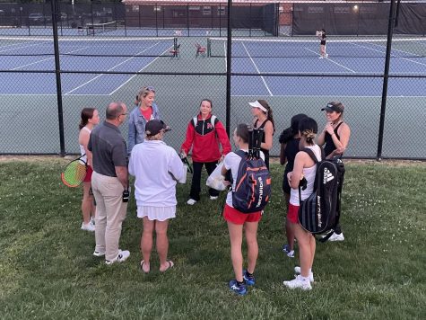 Members from McLean and Madisons tennis teams discuss terms for continuing the postponed matches on Tuesday.