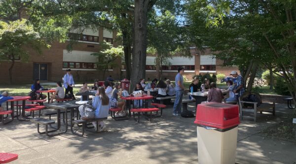 Students eat lunch in the courtyard, one of the four areas currently available for them under the new policy.