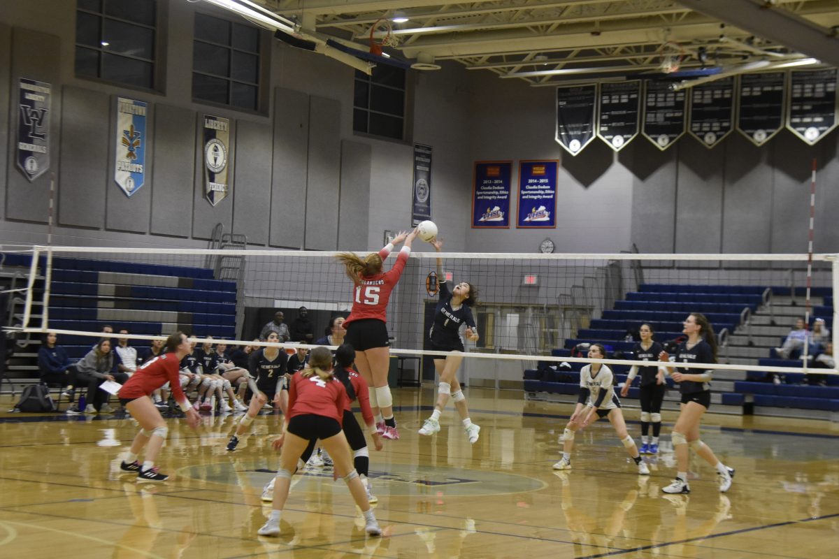 Senior MH Rosie Degn jumps up to emphatically block the spike from the Generals.
