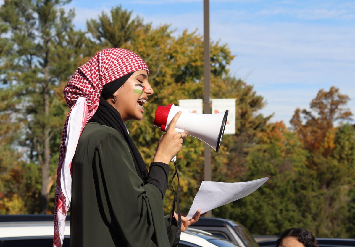 Sophomore Holly Raheb leads protest as students gather outside McLeans front entrance.