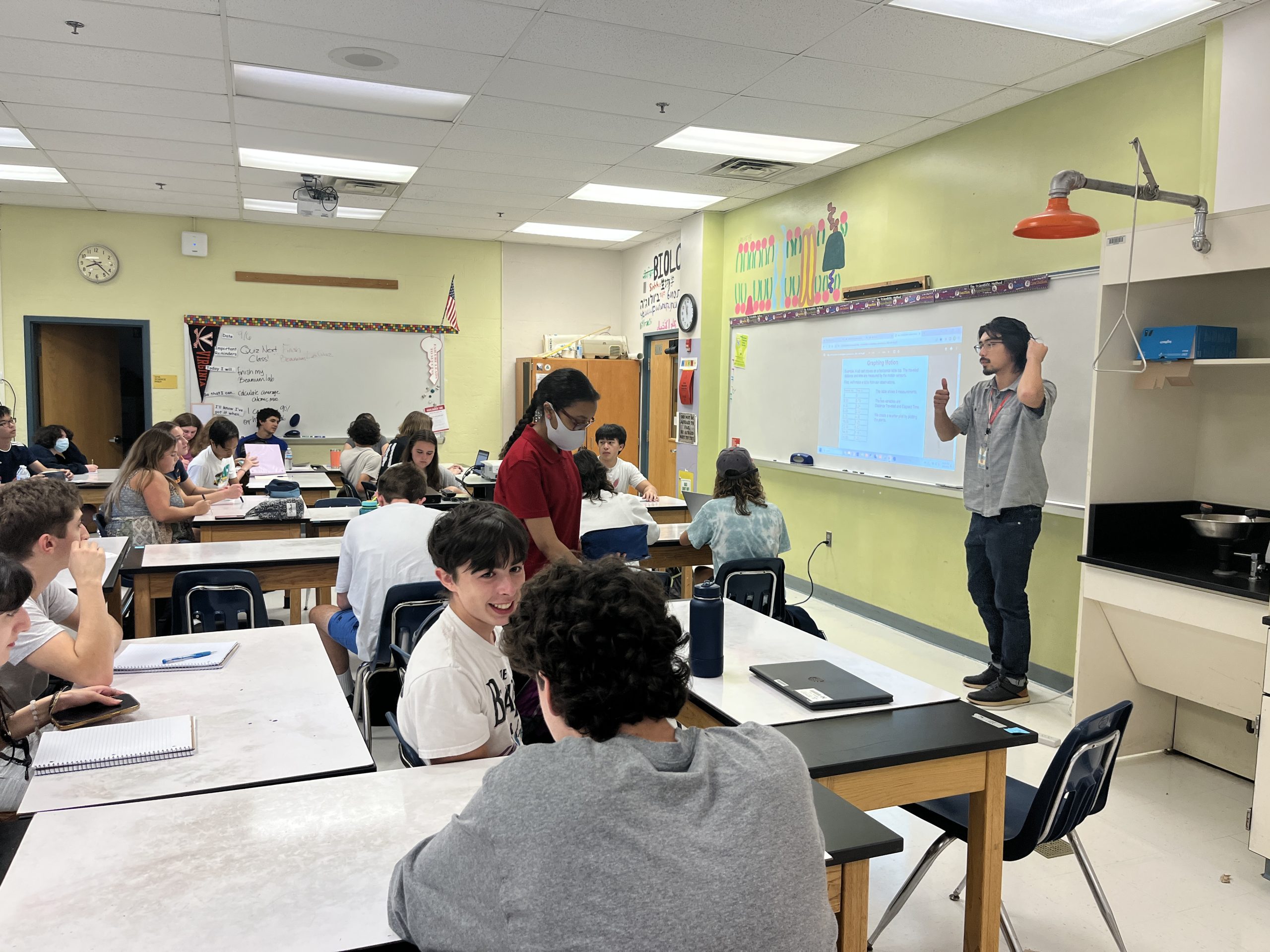 New physics teacher Joseph Kin explains the warm up for his Physics 1 class. Kin frequently uses math-focused warm-ups in class, using review of past material to make the learning of new physics concepts easier.
