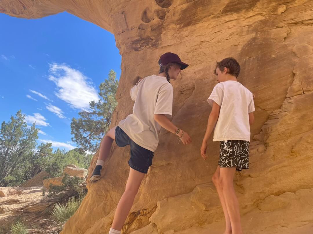 Senior Riley Purcell guides her brother through the basics of rock climbing. Part of rock climbing culture is to be supportive of those who are still learning the ropes.