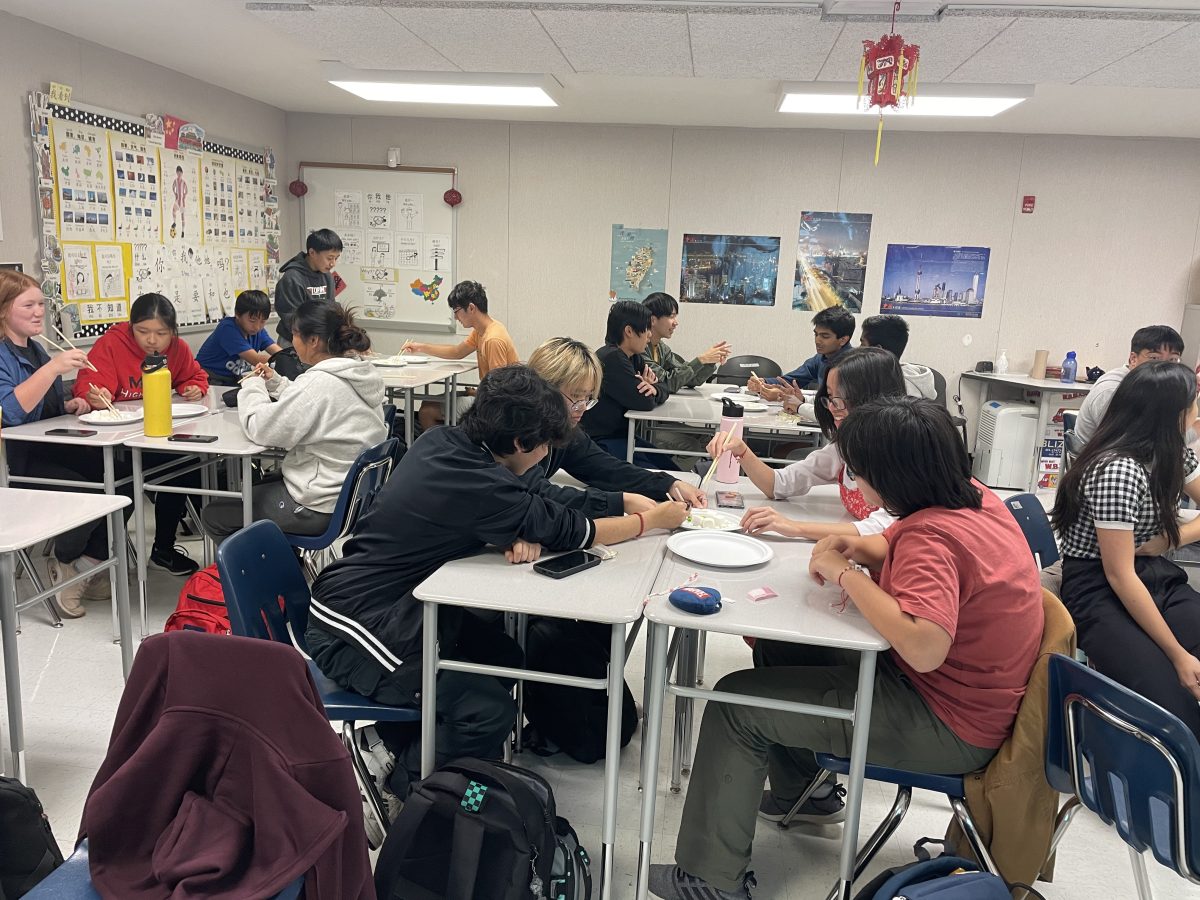 The Asian American Association meeting in Mrs. Pearsons room. Last meeting, they played a game after learning about chopsticks, where they attempted to pick up candy and move it from one plate to another.