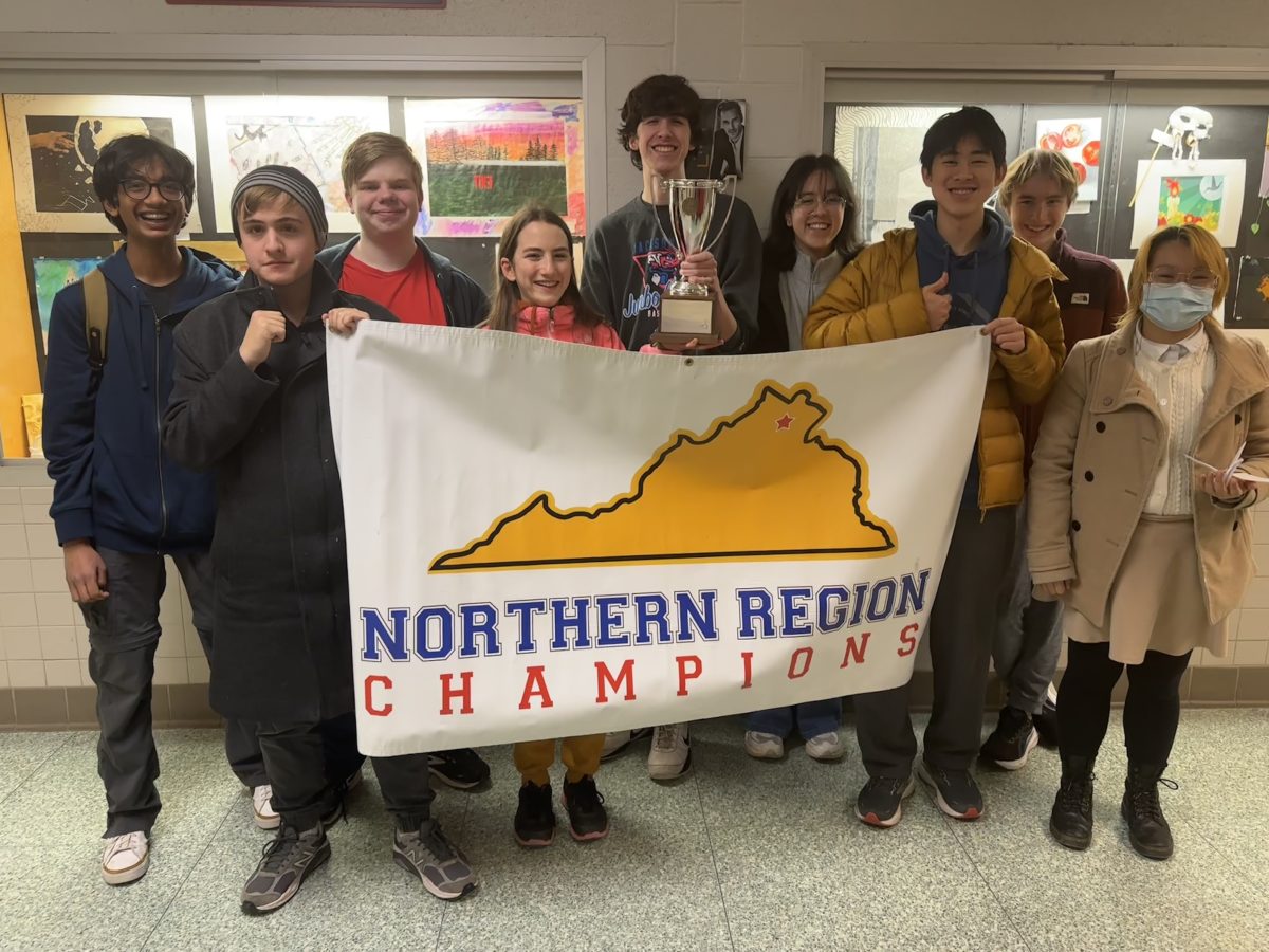 McLean quiz bowl poses holding their regional champions banner after a win last Wednesday. That victory will advance them to the state tournament on February 24.