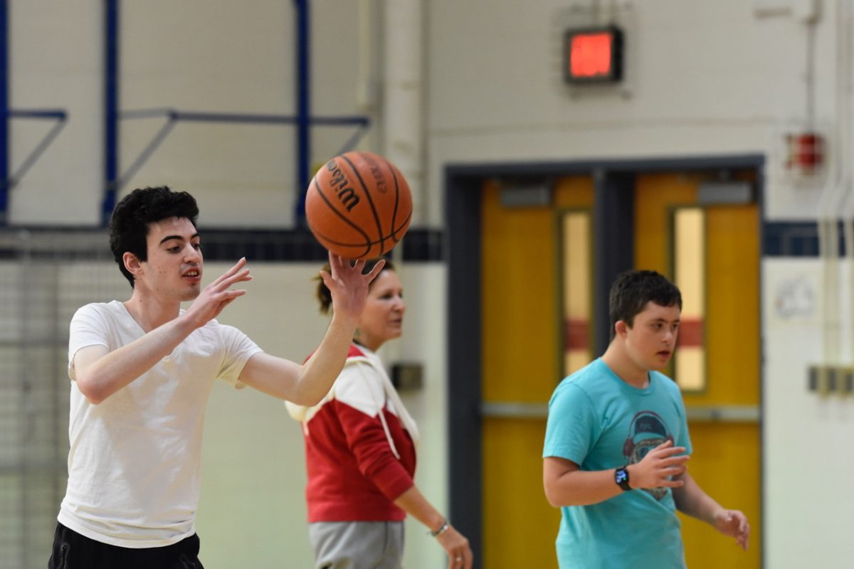 Athletes work on hand-eye coordination by practicing passing drills with partners. 