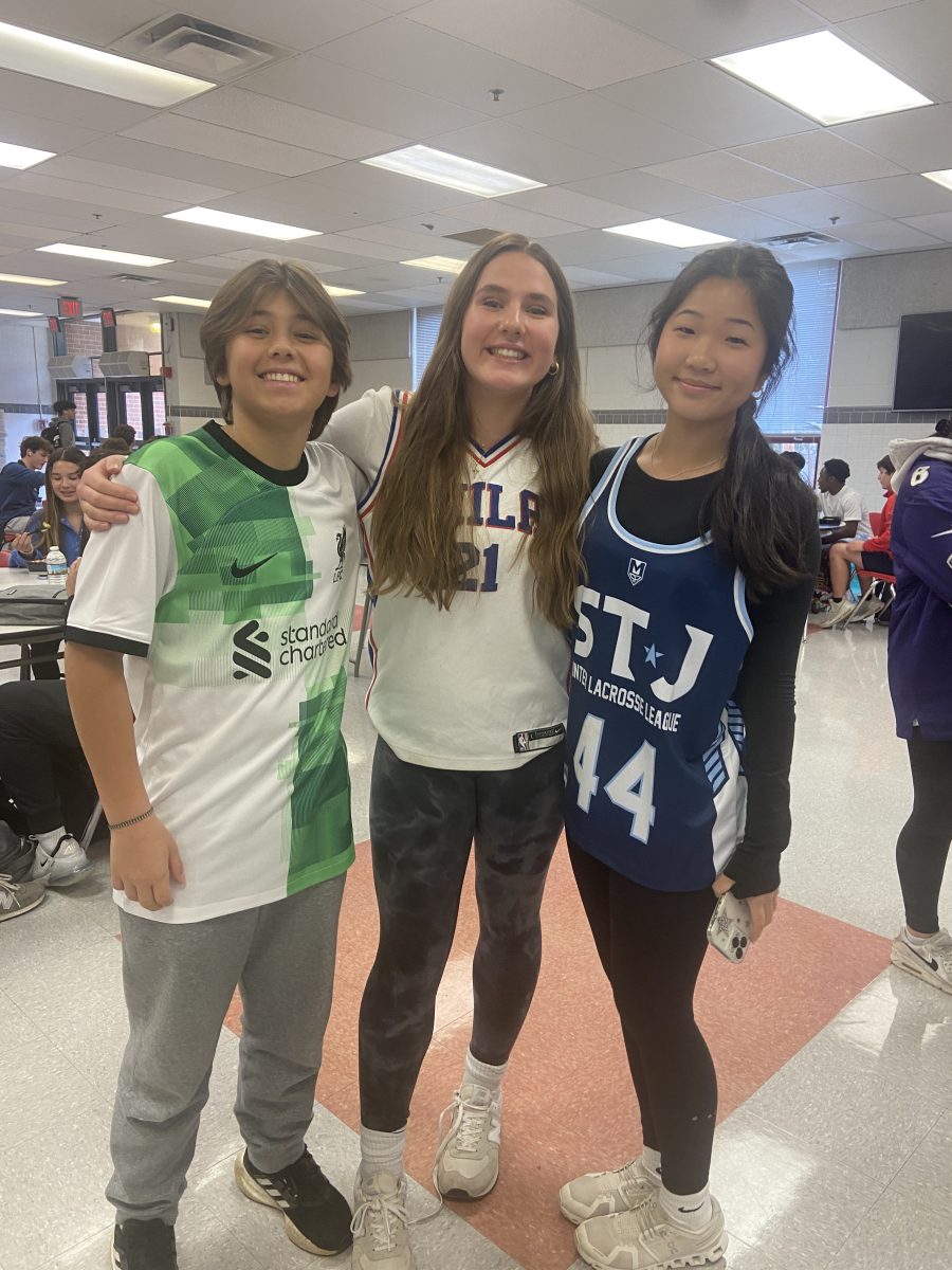 Freshmen Mia Jander, Eva Braccia and Ben Urwin Pinto wear their jerseys for Wednesdays spirit day.
