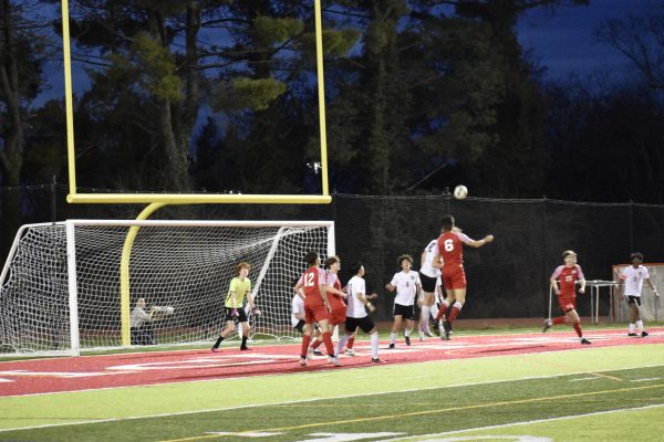 Senior defender Dante Tosado leaps into the air to attempt a header off of a corner kick. Tosado, a dynamic defender throughout the game, prevented the warriors from scoring several times. 