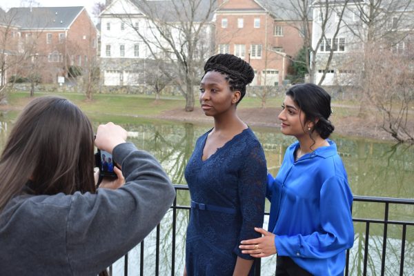 Sophomore Publicity team shadow Micah Chlan photographs cast members senior Taylor Konditi (left) and sophomore Aashna Kapur (right). Cast members posed for photos taken by the publicity team to post on TheatreMcLean’s social media and website to promote “Anastasia.”