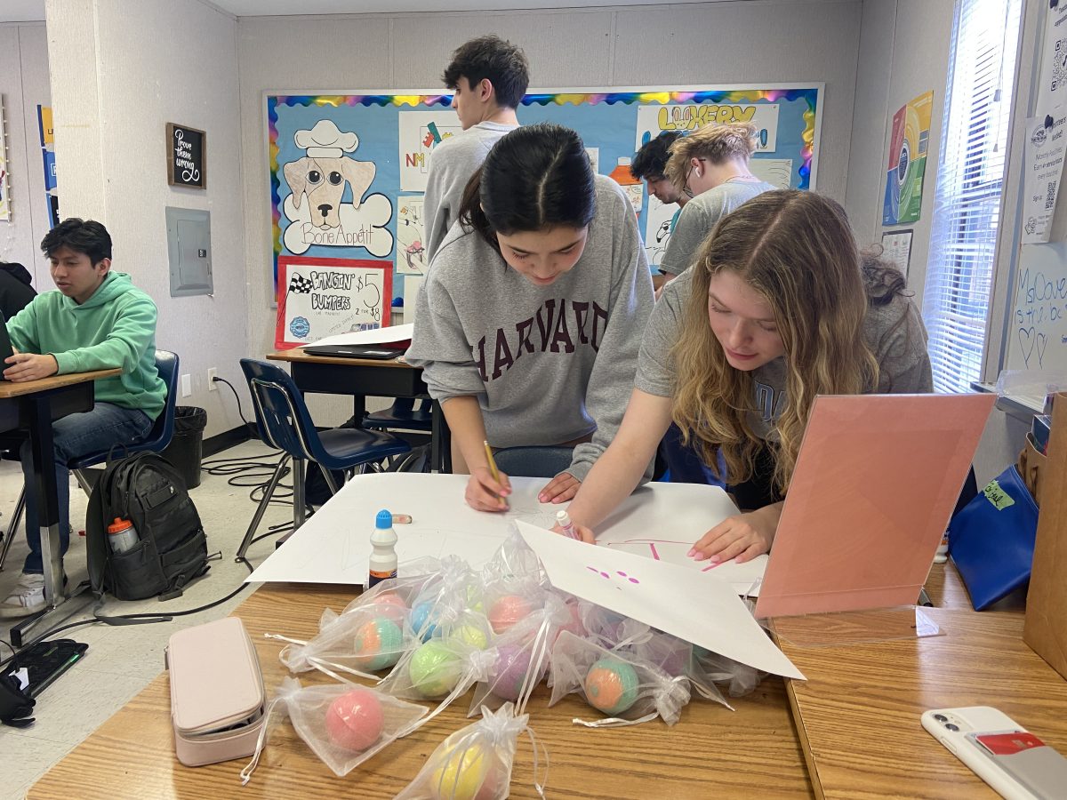 Bath bomb products are made and ready to be sold for Mar. 8. Students decorate an eye catching poster to garner attention.