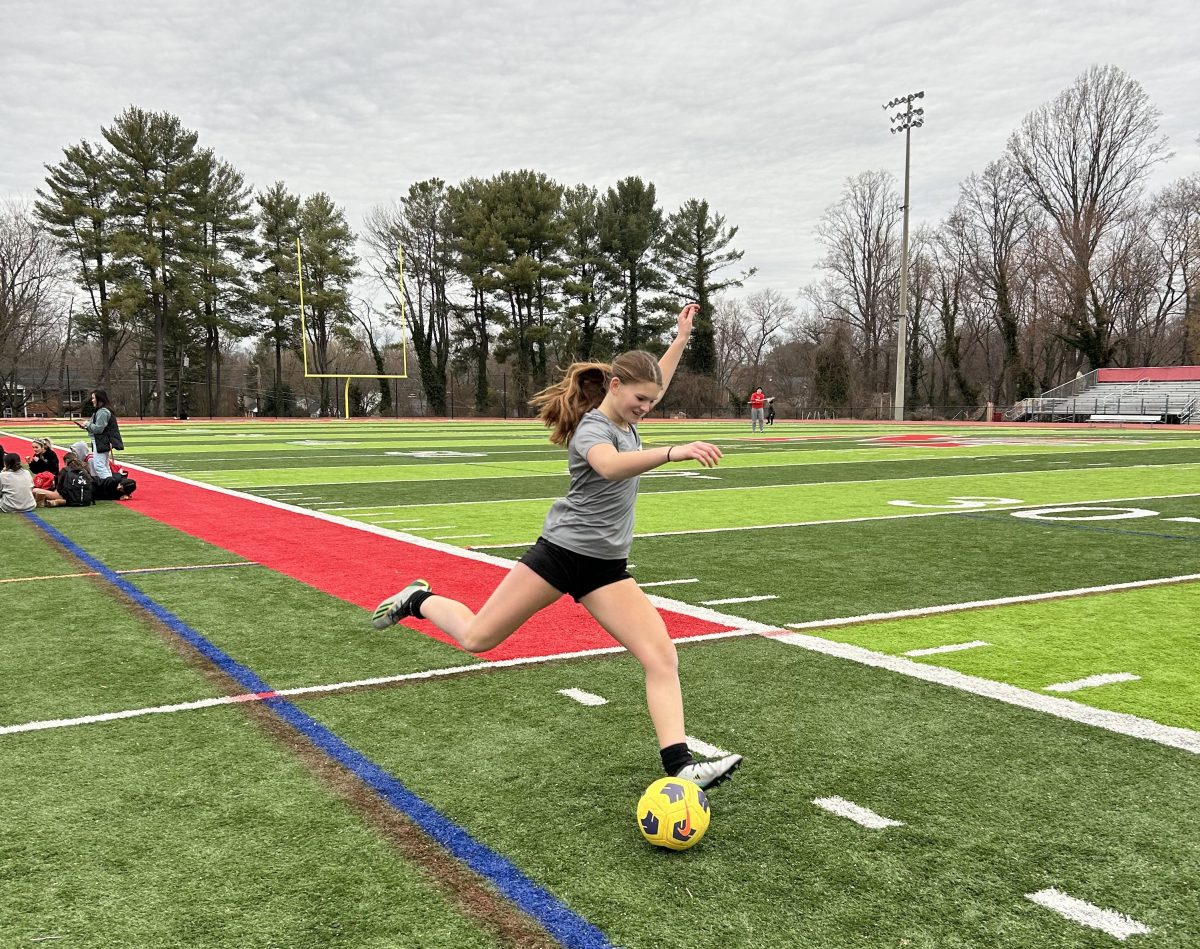 Sophomore goalie Aimee Abraham practices her kicks on the sideline. 