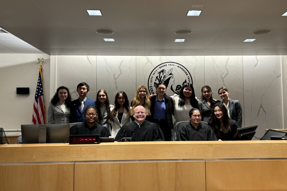 The Mock Trial team standing behind the judge panel at the state competition. The competition was held at Henrico County Circuit Court. 