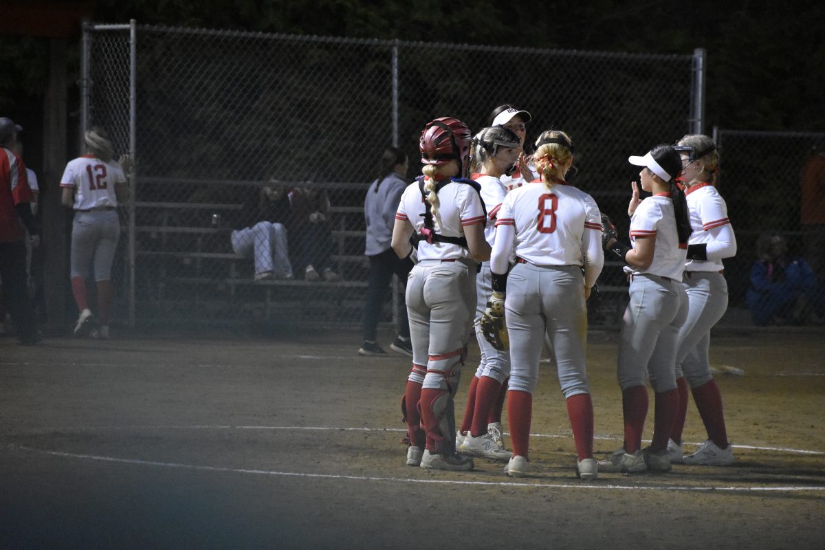The Highlander infield congratulates junior pitcher Hailey Simpson after a strikeout. This is a recurring occasion, as the team is very connected.