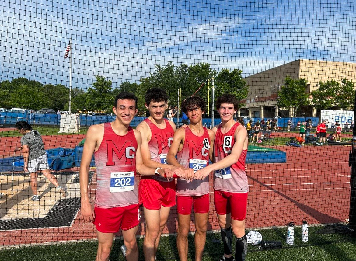 The 4x800 meter relay team consisting of seniors Luca Hinton, Liam Riley, Jackson Coombes and junior Landon Moore pose after winning their race and qualifying for states. 