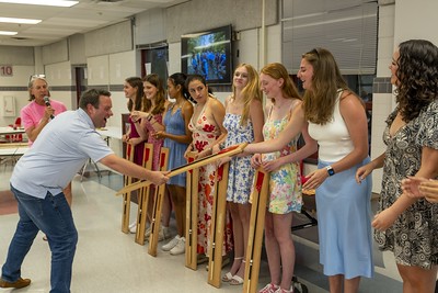 
At the crew banquet, Coach Nate McClafferty gives the seniors of the girls team their senior plaques. These plaques have the name of each senior on it along with an oar, so they can remember their high school experience in crew. 