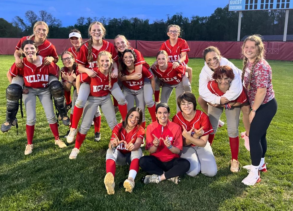 Manager Izzy Vanegas posing with the JV softball team after securing a win against Marshall. With Vanegass help, the team trumped Marshall 18-1.
