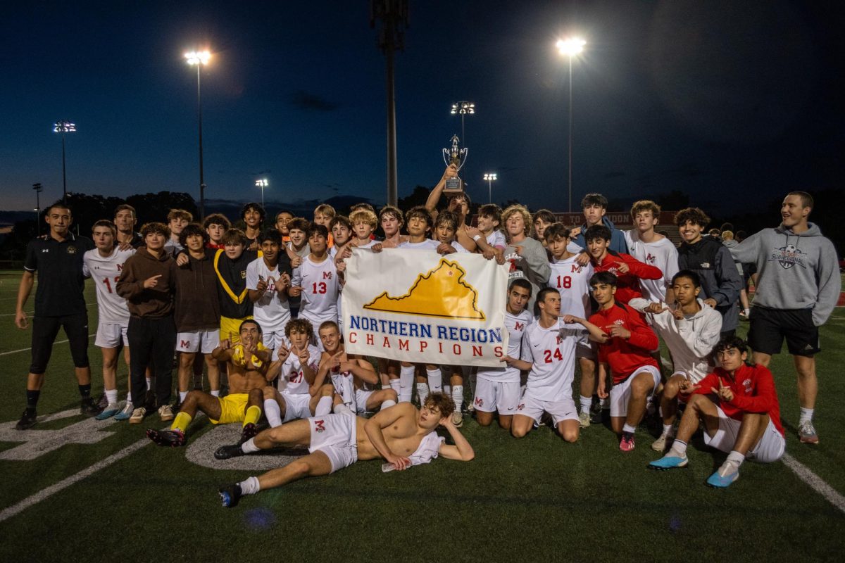 McLean's boys varsity soccer team poses with the banner and trophy they received for becoming Northern Region champions. Game-winning goal scorer Luke Hamel holds the banner for his team.