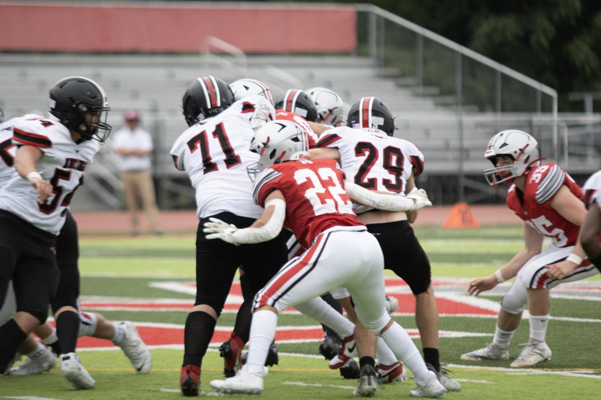 Senior Linebacker Thomas Terminella maneuvers his way through a jumble of offensive linemen. The Mustangs tricky run schemes led to confusion in the McLean defense.