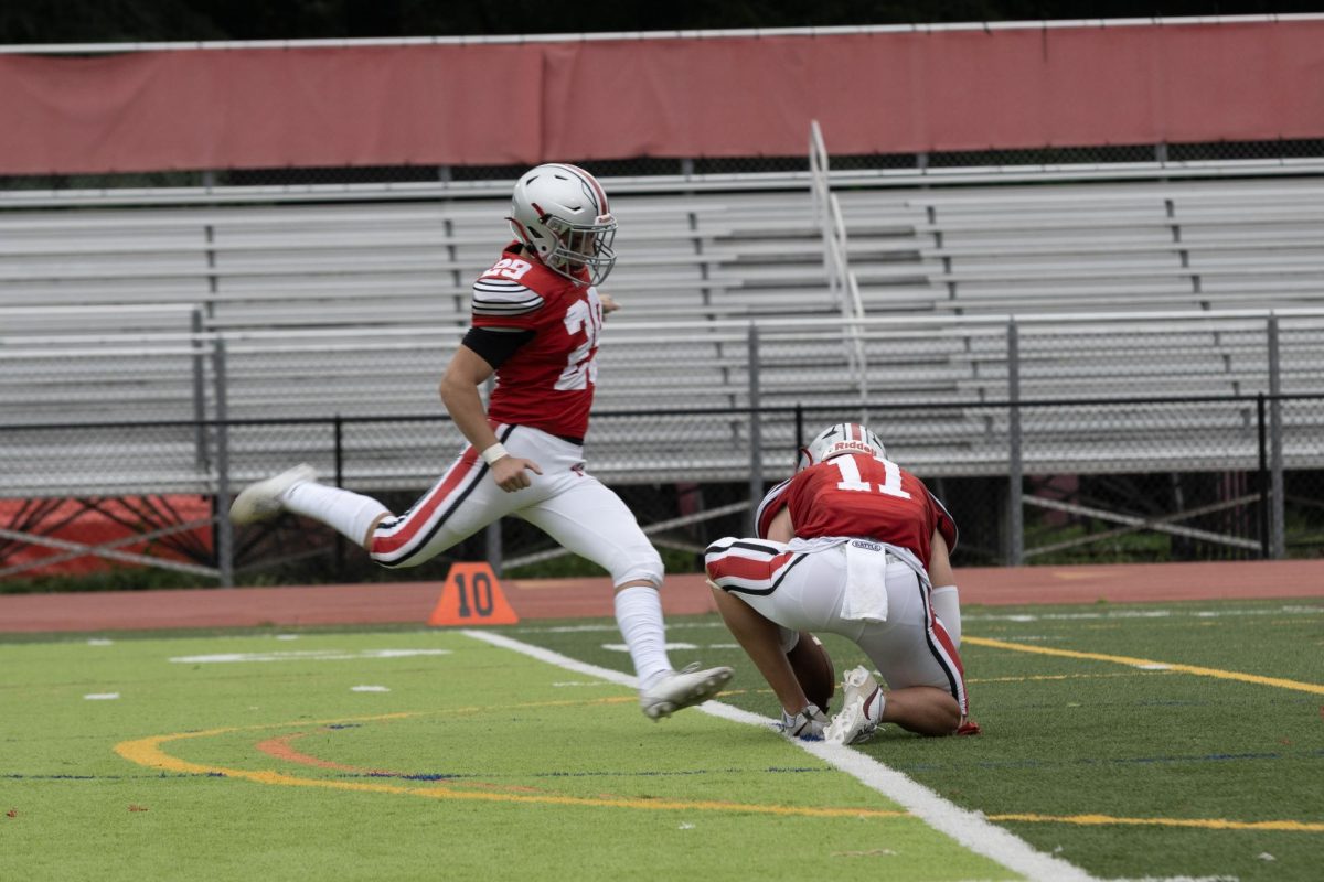 Senior Kicker Nathan Bender kicks through the ball for a successful extra point. Special teams struggled with their snaps, resulting in two blocked extra points.