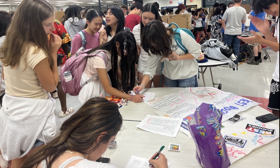 Students interested in the Best Buddies club visit the club's booth to gain information, along with a sweet treat. 