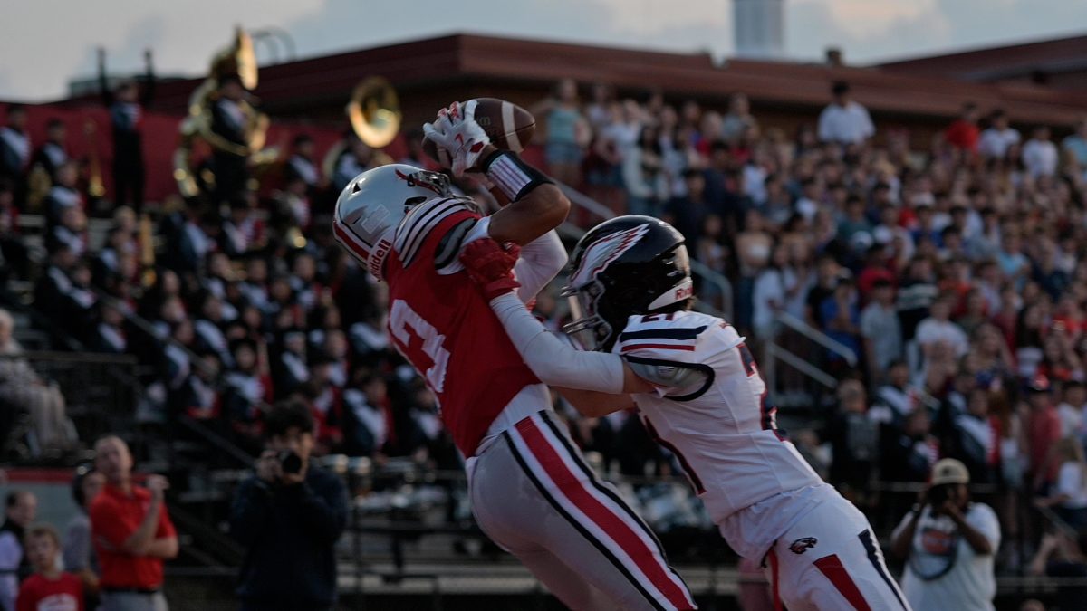 Senior wide receiver Sebastian Carmanetes makes a tough reception, undeterred by the contact from an Edison defender.