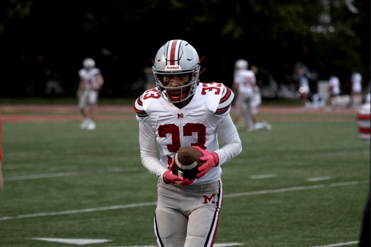 Junior cornerback Justin Cossio catches a pass during McLean's warmup.