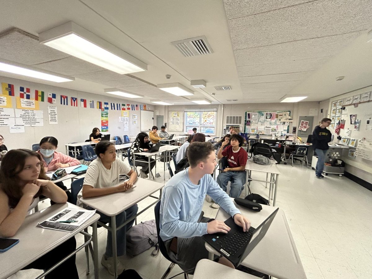 Latin club members listen as Consul John Farrell walks through the entities of Lemuralia, the Roman version of Halloween. The club learned about various ancient traditions that are similar to modern Halloween practices.