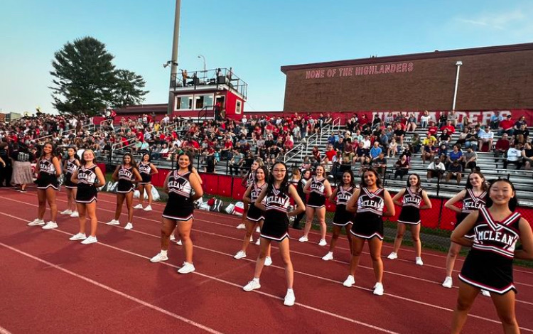 McLean dancers stand in front of the parent section at the football game against Edison. This is the first year that the dance team has cheered on the track. 