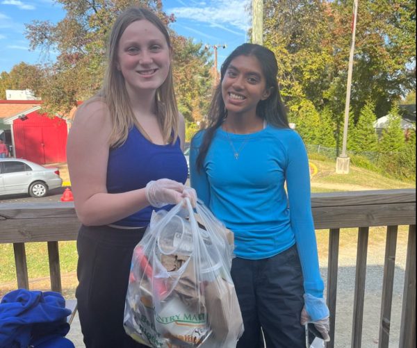 Club members demonstrate their commitment to environmental cleanliness by holding collected trash picked up across the McLean campus.