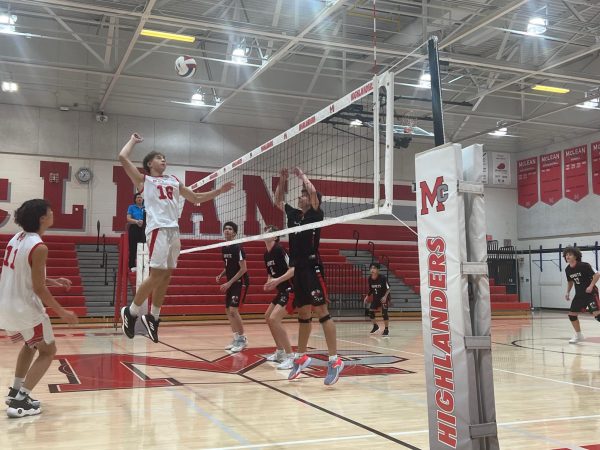 Middle hitter Sawyer Dolina leaps to slam a spike into Herndon's defense. 