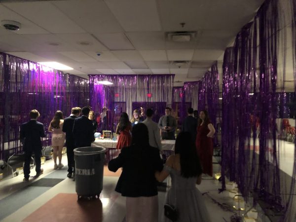 Students check in in the cafeteria before continuing to the gym. After buying the Homecoming tickets on Etix, students were required to show a receipt before going to the dance.