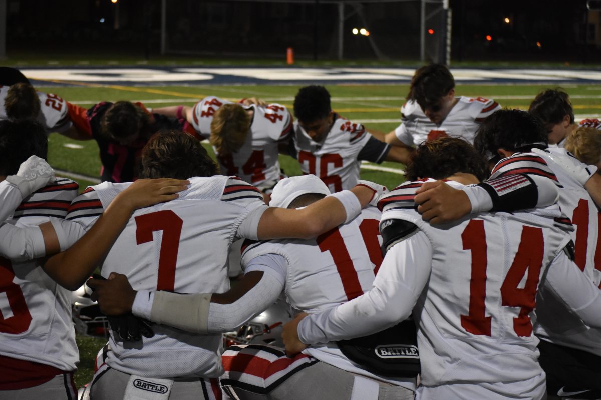 Highlander players pray before their matchup against the Generals. This is a weekly occurrence for many of the McLean players before every game. 