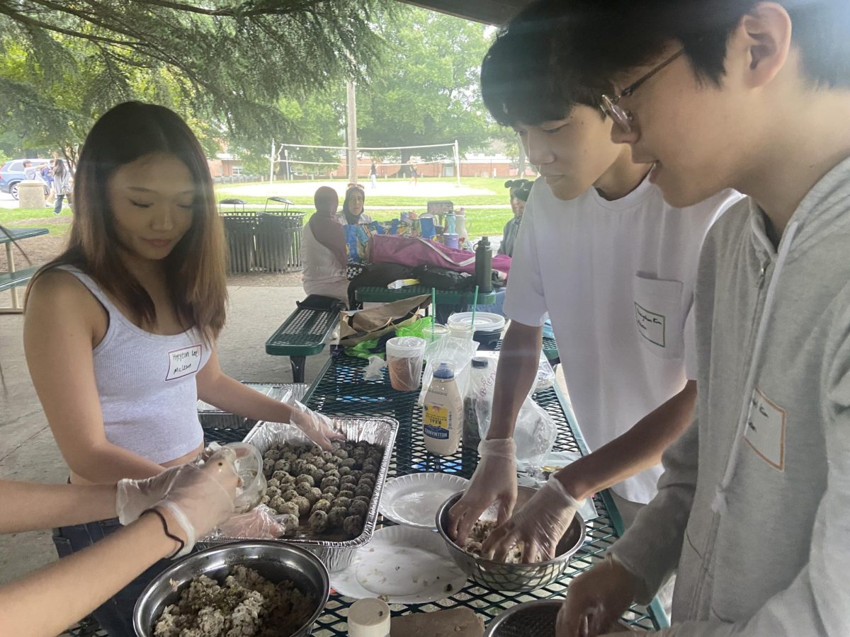 McLean Korean Club officers prepare rice ball snacks for members. The Korean dish, also called Jumeokbap, is commonly enjoyed as picnic food as it is easy to make.