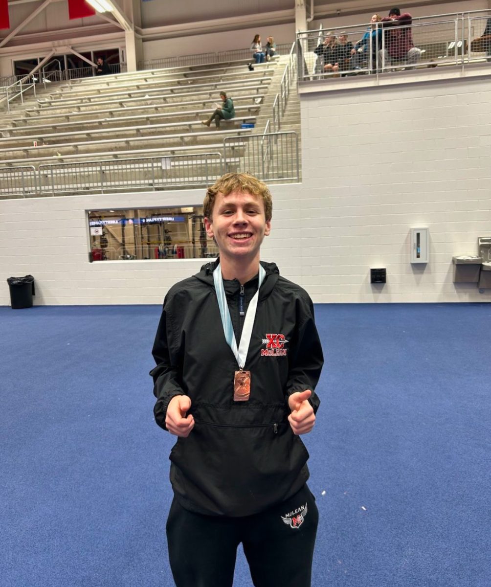 Junior Carter Lineweaver poses with his bronze medal after completing his 2 mile race. Lineweaver dominated this race, breaking the previous school record.