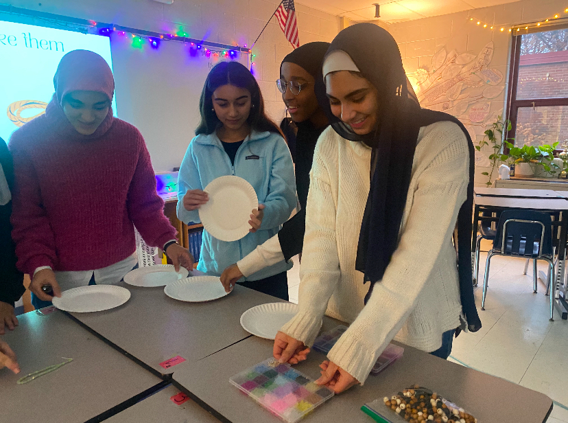 MSA members gather to create prayer beads using strings and a variety of different colored beads.