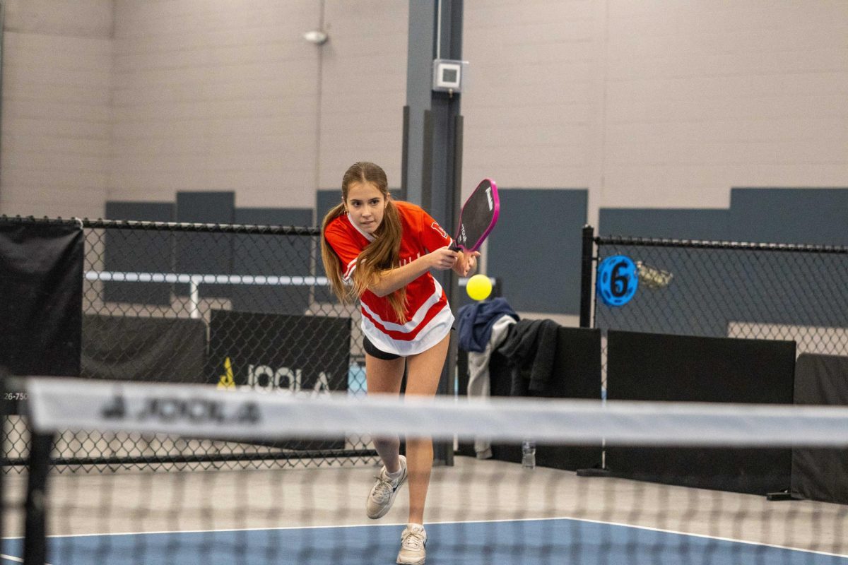 Sophomore Anna Polykoff rallies a shot over the net during her first set of the evening, with an eventual 15-8 set win.