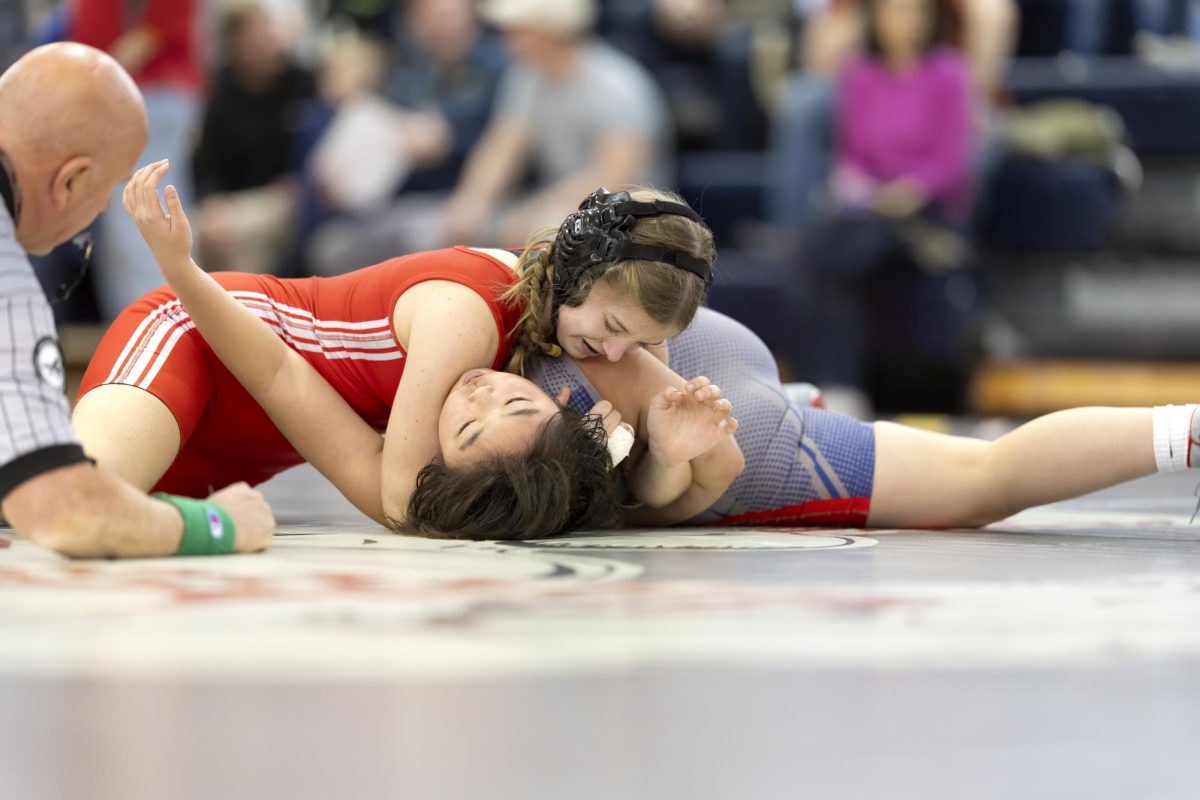 Sophomore wrestler Lily Kilgore skillfully pins her opponent at the annual alumni meet.