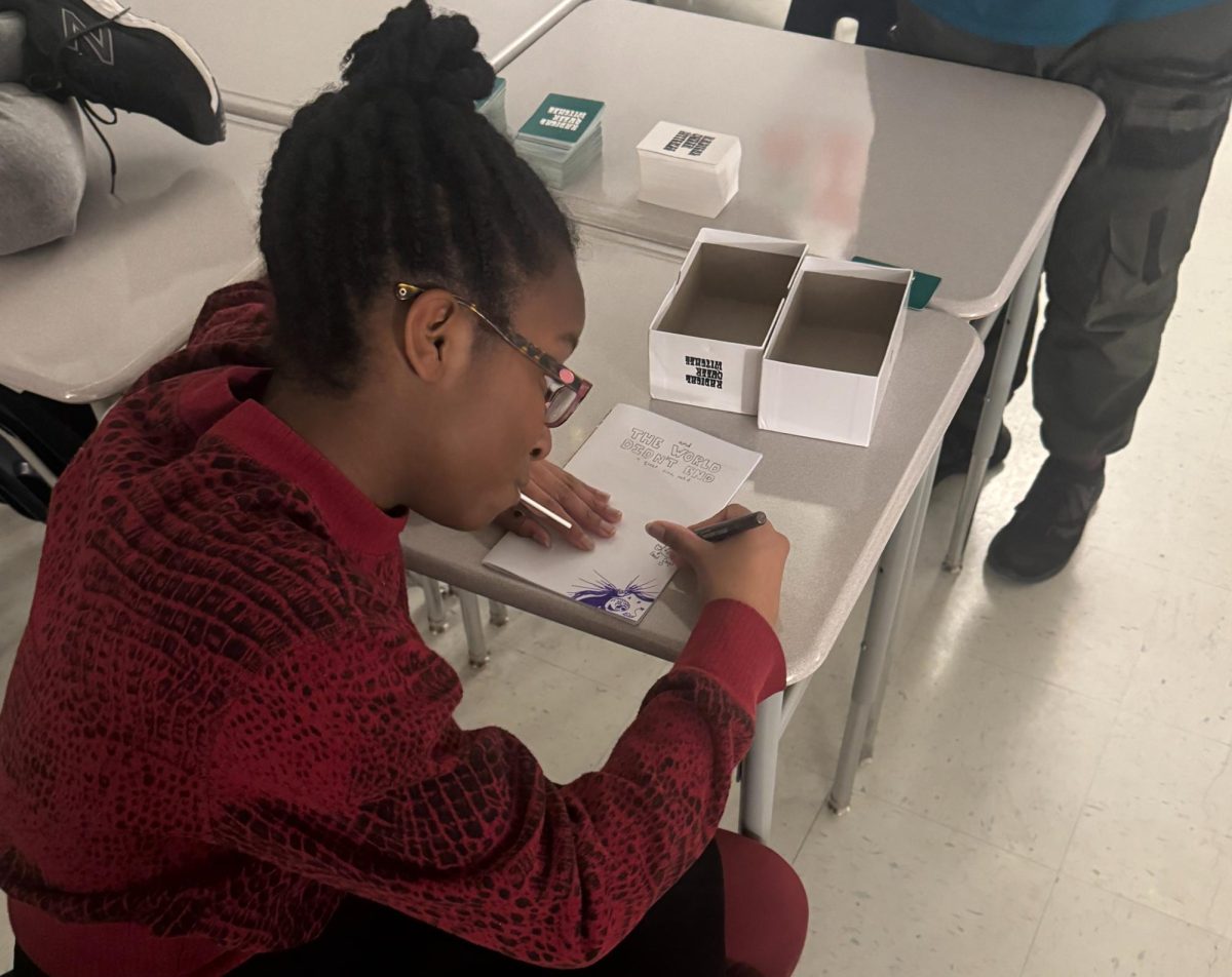 Senior Imani Battle draws on the cover of the GSA's new zine. Students gathered at a meeting on Jan. 24 to help design and finalize the cover and pages before it's publication.