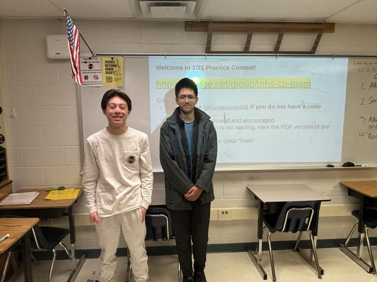 Senior co-captain Eric Xue and sophomore member Kalan Warusa pose for a photo after competing at the MIT Informatics Tournament.