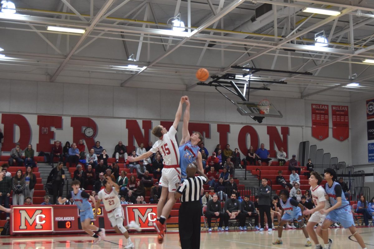 Senior Avery Higgins bounds upwards for the tip-off. Higgins would tip the ball directly into the hands of McLean's shooting guard, junior Logan Baldrate. 