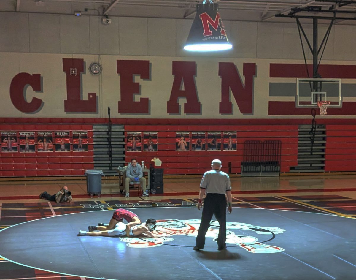 Varsity wrestlers take on their opponents with fierce determination and sportsmanship, making sure that this night goes down as another win in McLean's undefeated season.