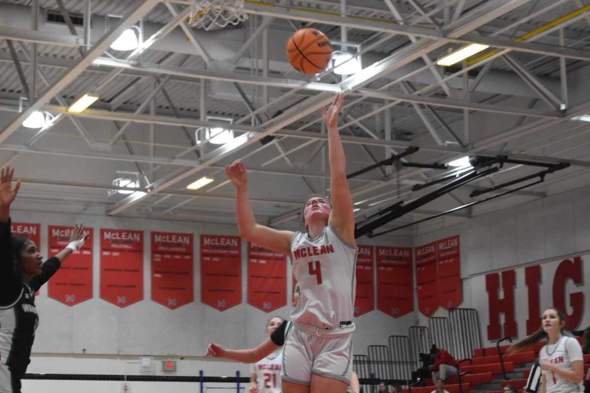 Senior Ally Hodder reaches up for a rebound. Hodder contributed to dominant interior play, scoring many points and getting many rebounds. 