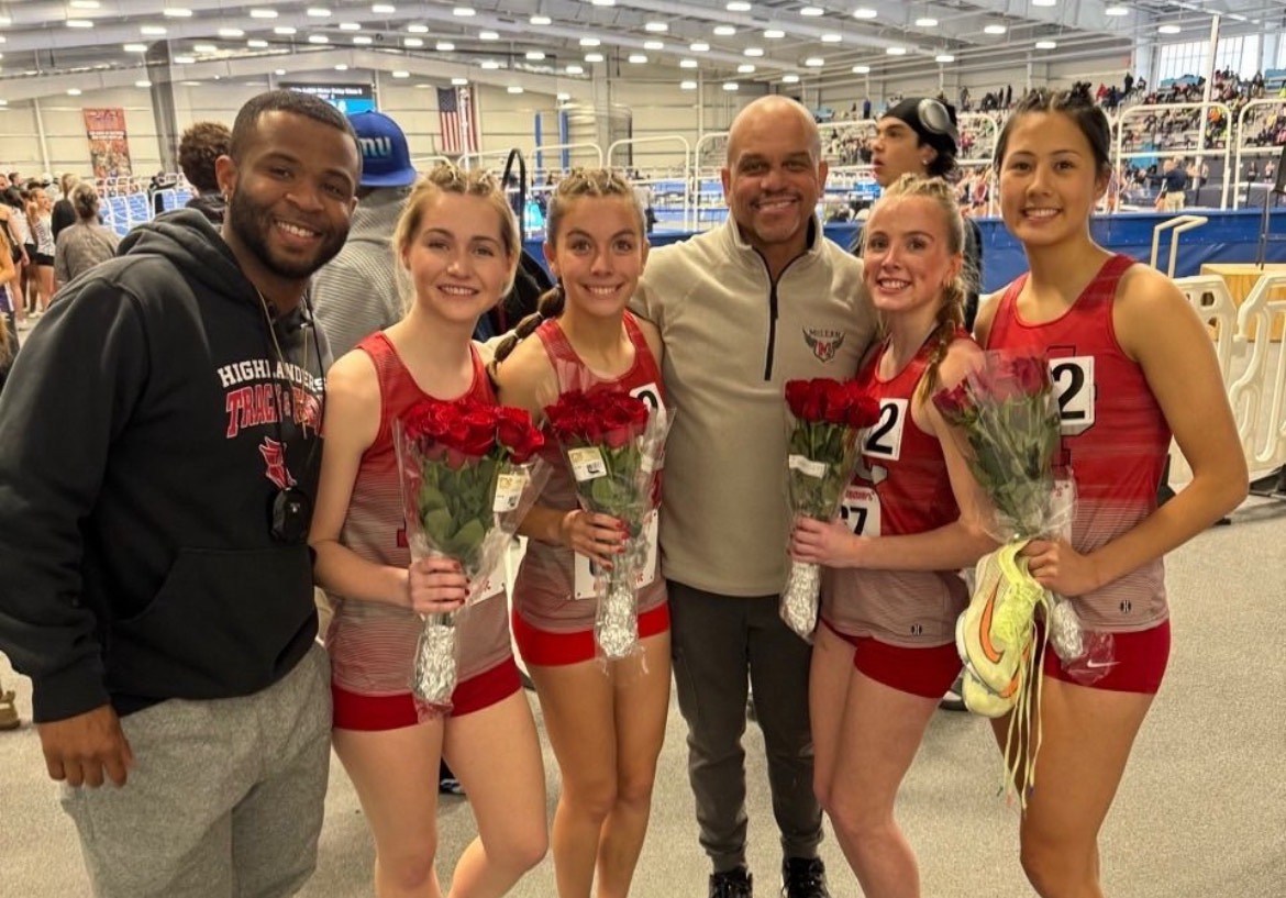 After receiving All-State Honors for their seventh place finish in the 4x800 meter relay, junior Kathryn Thomas and seniors Addison Buday, Caitlin Farley and Calypso Rolly celebrate with their coaches and flowers. This pairing also ran the 4x400 meter relay, placing 15th.