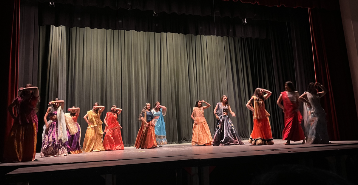 South Asian students perform cultural dances with dynamic moves.