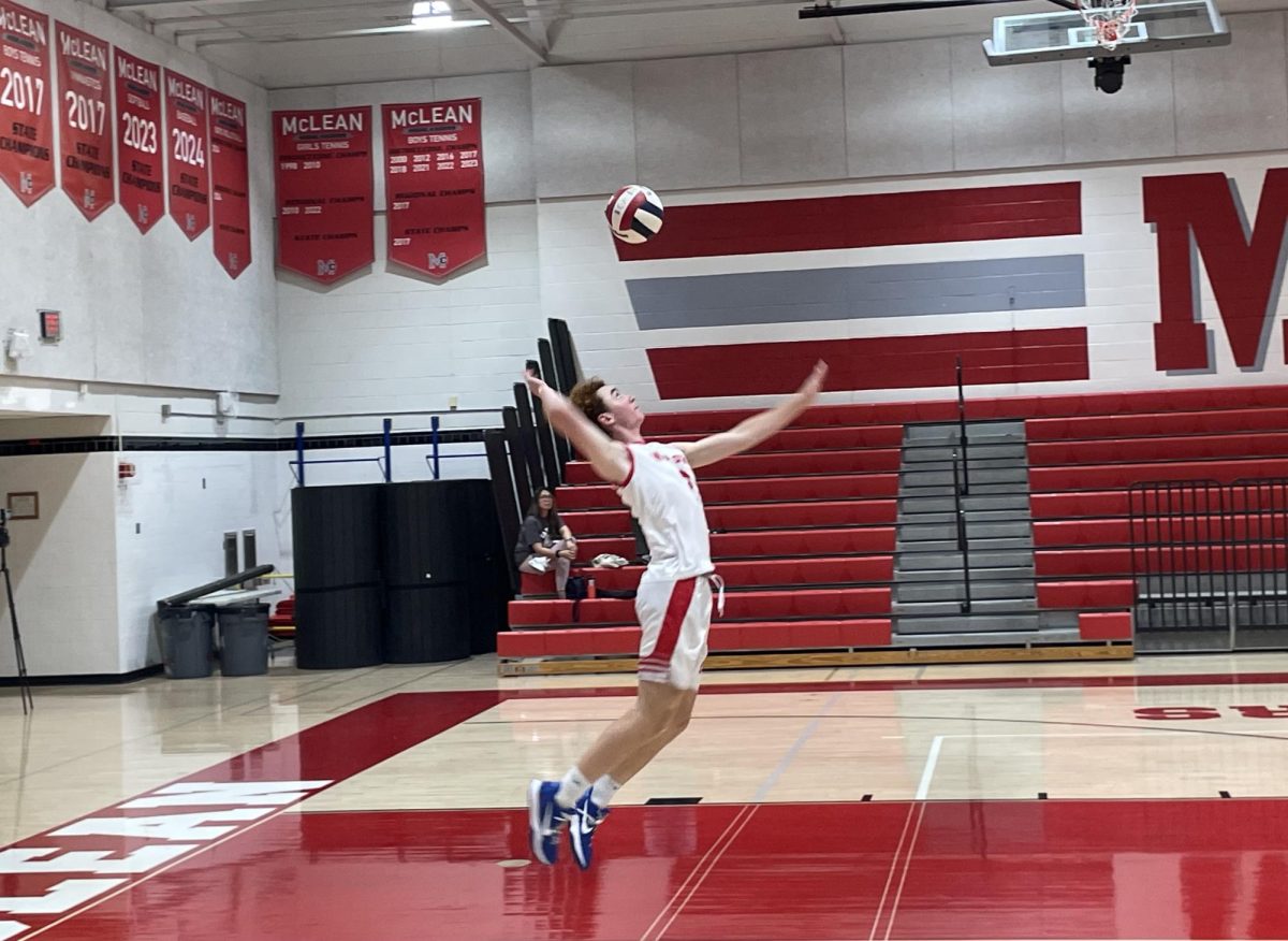 Junior Outside hitter William McGinnis rises up for the serve against Madison on Sept 4. McGinnis was a crucial player, with his presence at the net providing several points for the highlanders.